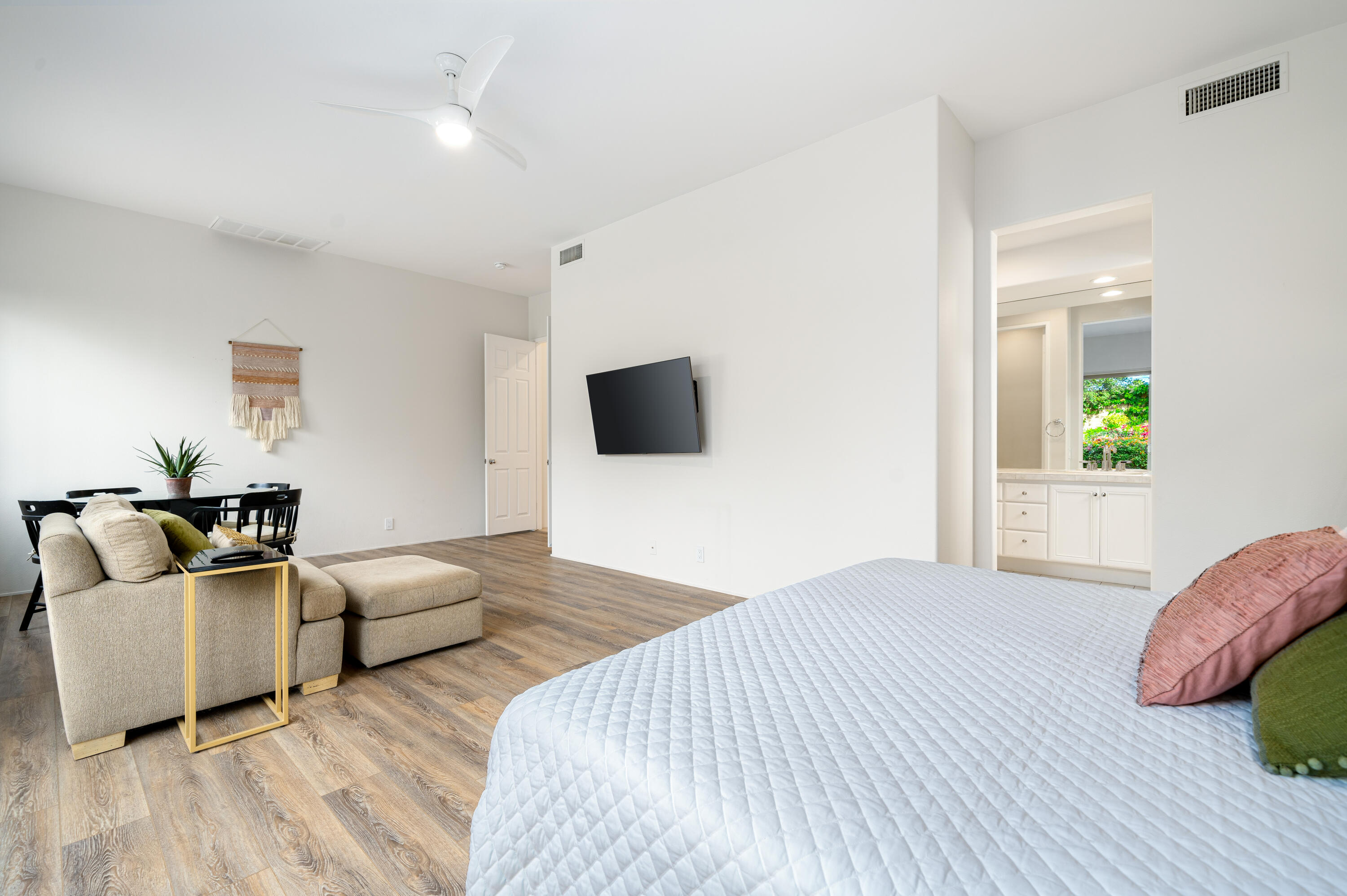 79060 River Rock Road La Quinta, CA 92253 - Photo 19 of 36 a spacious bedroom with a bed and a flat screen tv