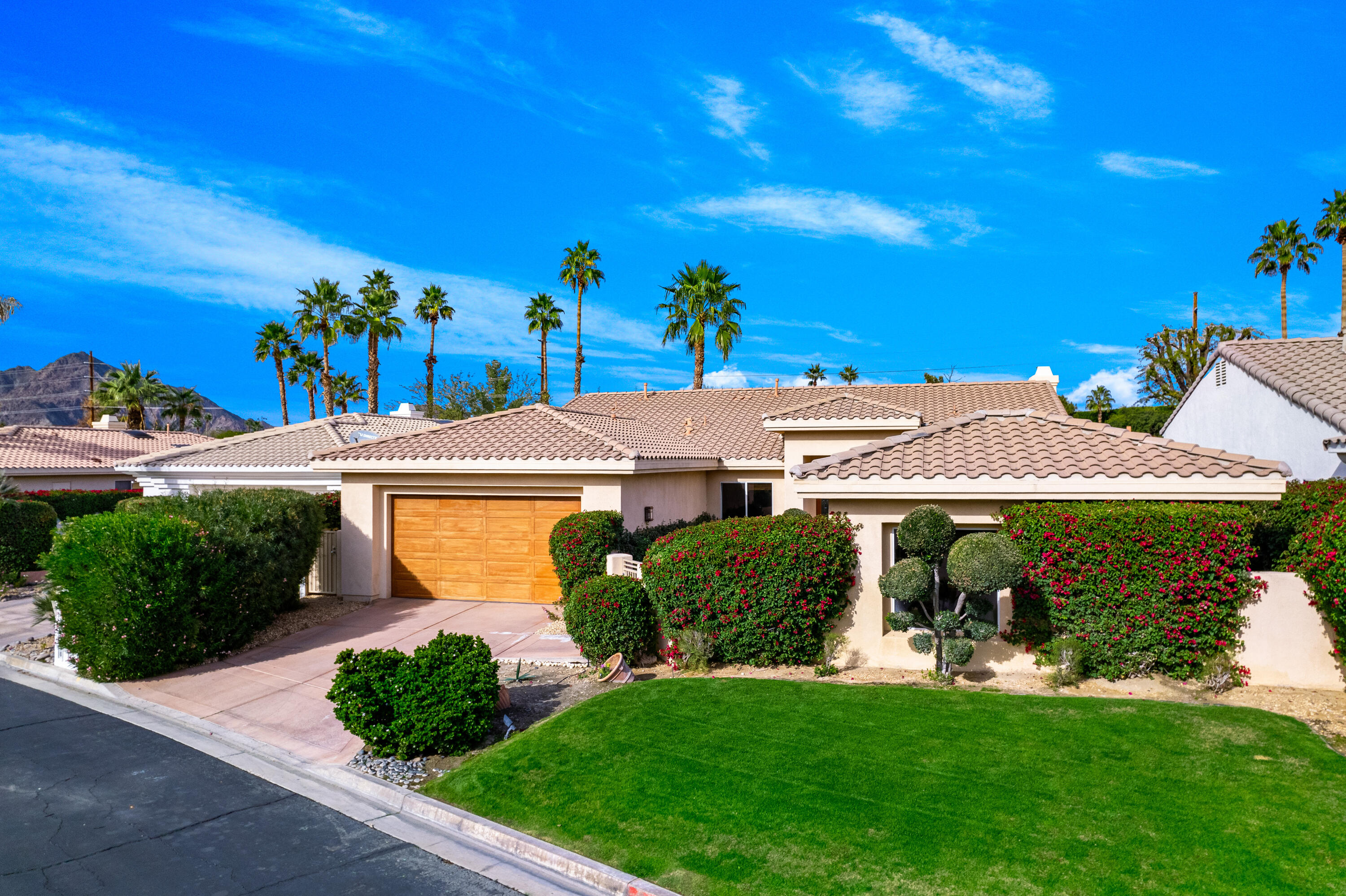 79060 River Rock Road La Quinta, CA 92253 - Photo 2 of 36 a front view of a house with garden