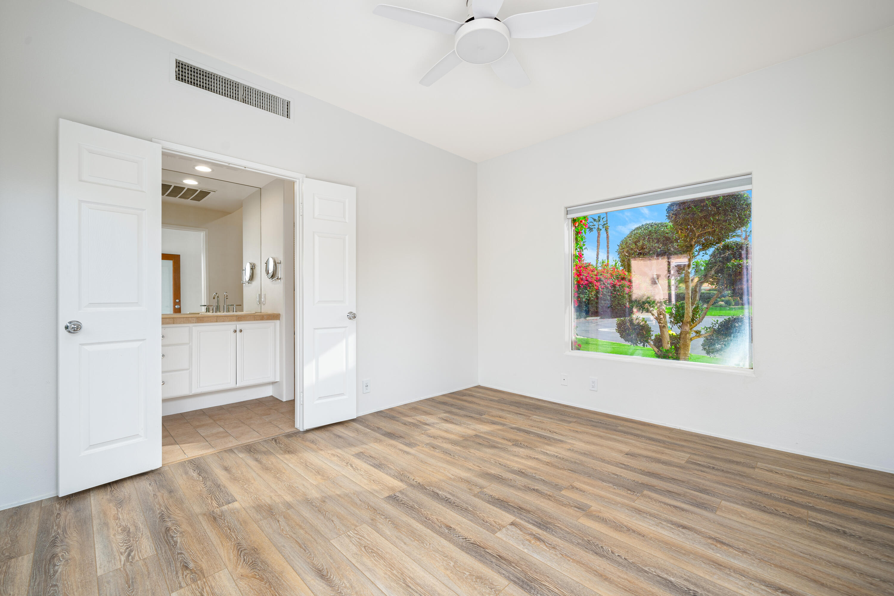 79060 River Rock Road La Quinta, CA 92253 - Photo 27 of 36 wooden floor in an empty room with a window
