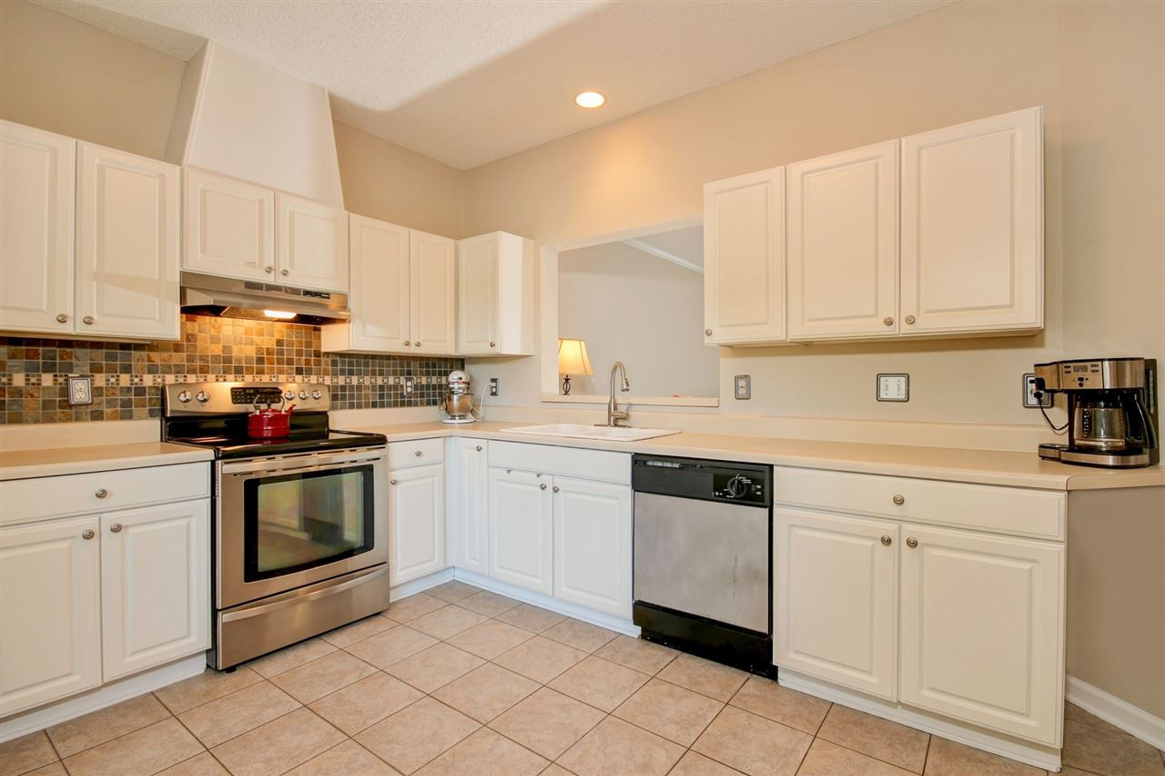 4402 Still Pines Drive Raleigh, NC 27613 - Photo 4 of 25 Watch the game while cooking for your guests in this updated kitchen featuring a tile back splash, tile flooring and stainless steel appliances. Kitchen