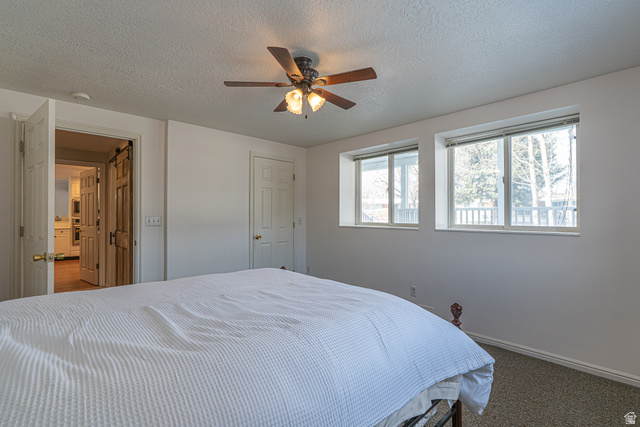 1045 Fox Farm Road Logan, UT 84321 - Photo 39 of 65 Carpeted bedroom with a textured ceiling and ceiling fan