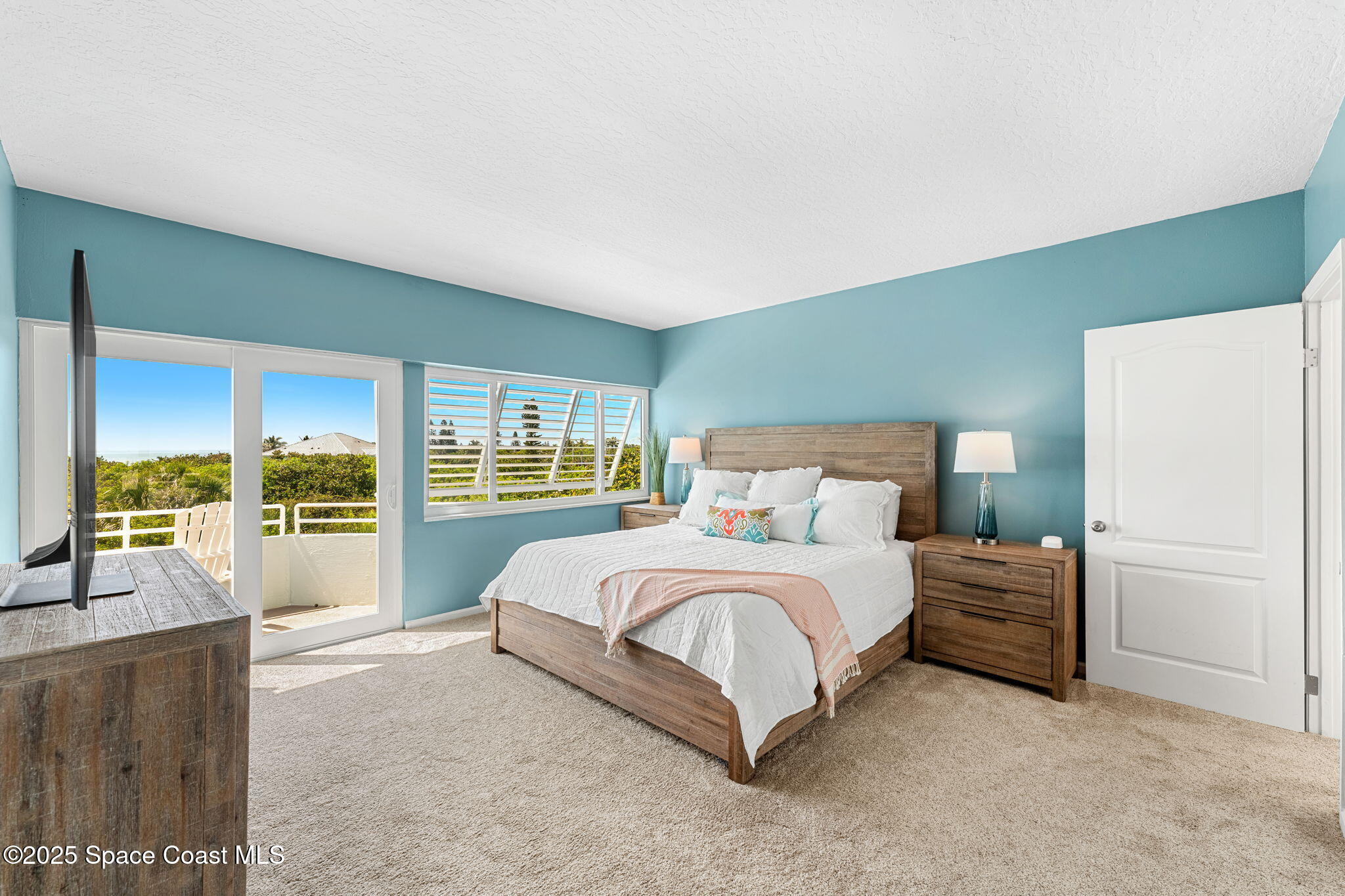 6355 South Hwy A1A, Unit 5 Melbourne Beach, FL 32951 - Photo 14 of 37 a bedroom with a large bed and a large window