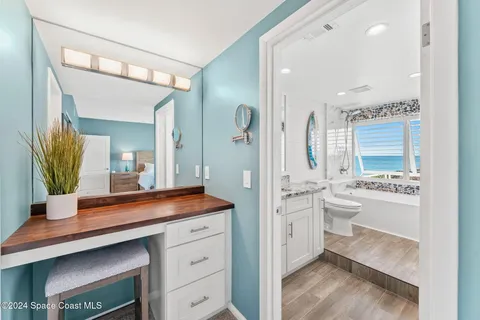 a spacious bathroom with a granite countertop sink and a mirror