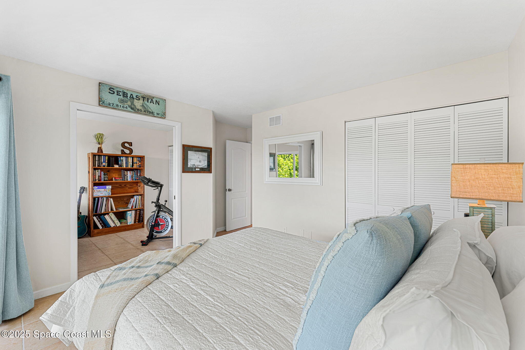 6355 South Hwy A1A, Unit 5 Melbourne Beach, FL 32951 - Photo 20 of 37 a bed room with a bed and a tv