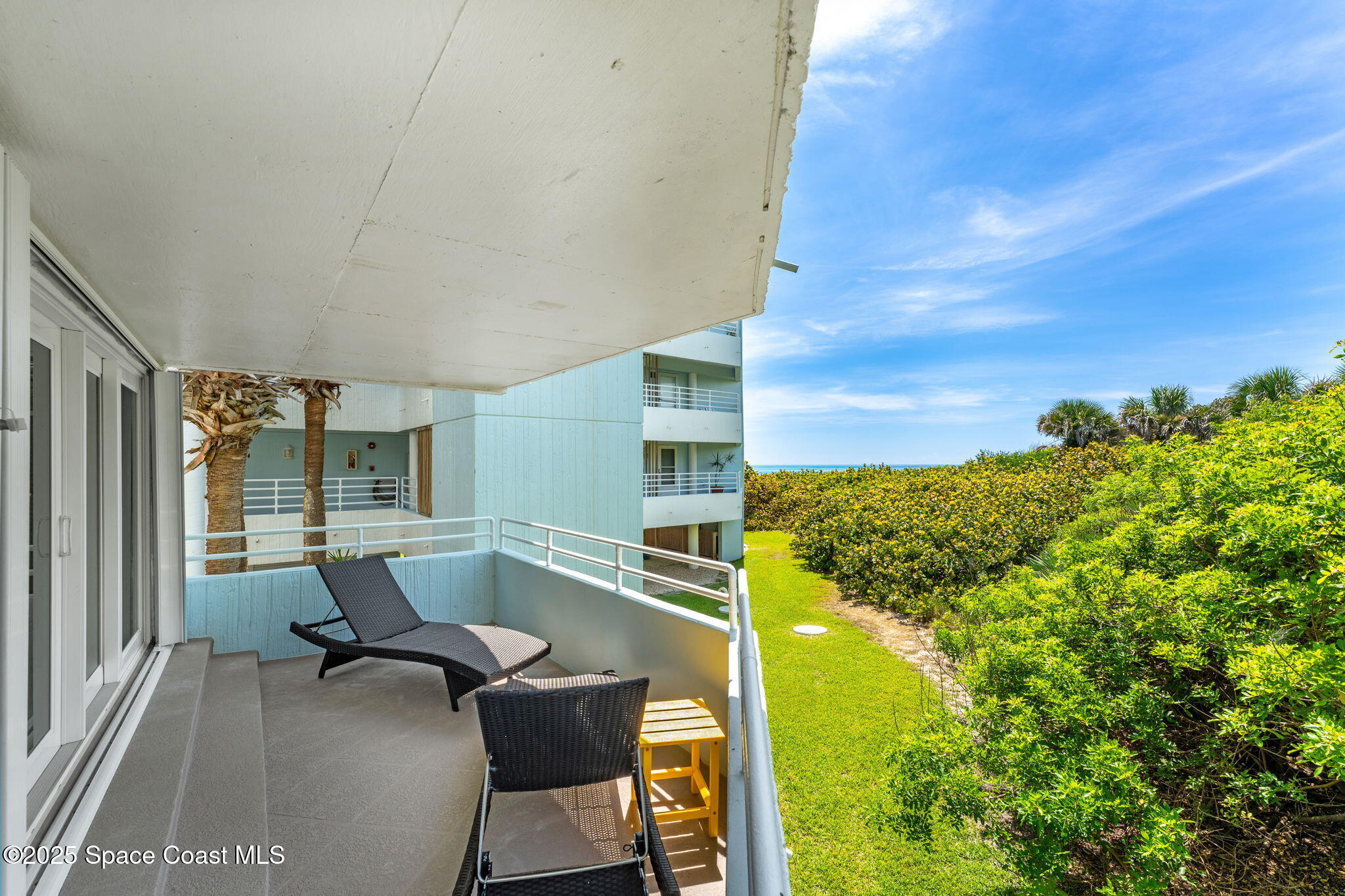 6355 South Hwy A1A, Unit 5 Melbourne Beach, FL 32951 - Photo 23 of 37 a view of a chairs and table in a patio