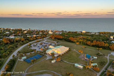 an aerial view of a house with swimming pool and lake view