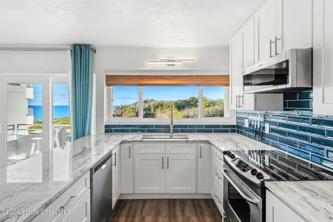 a kitchen with stainless steel appliances a stove sink and microwave