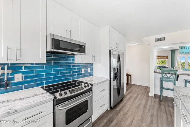 a kitchen with stainless steel appliances a stove microwave and cabinets