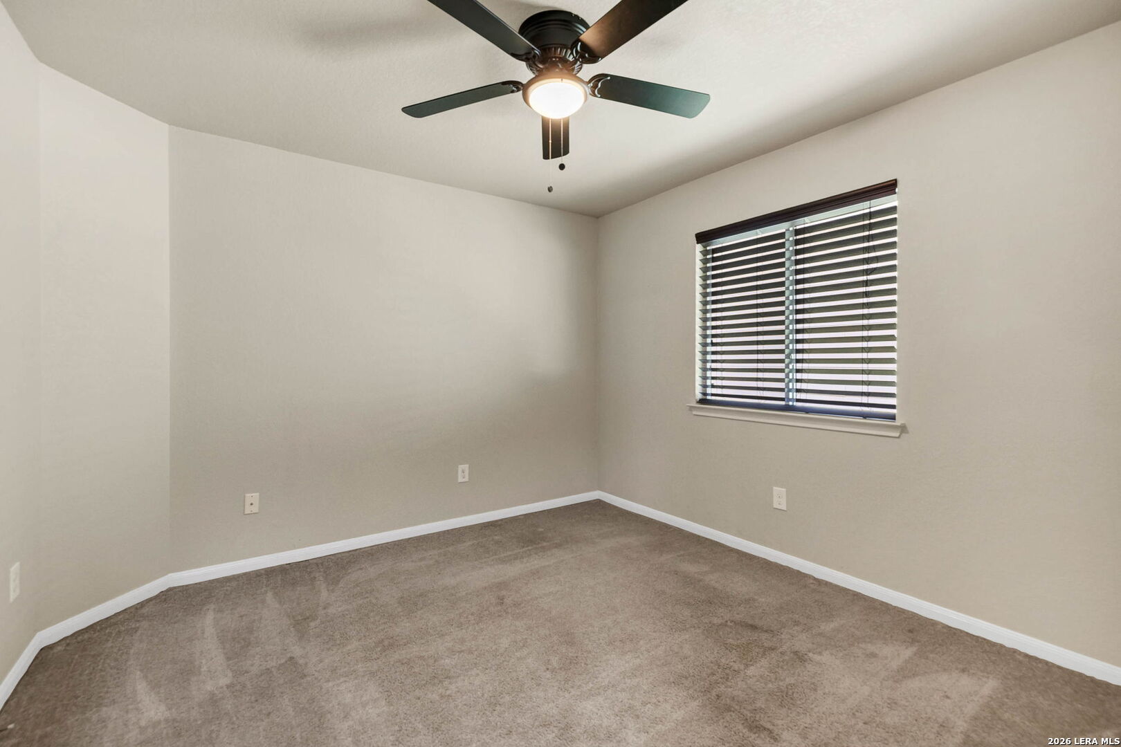 4015 Shervin Way Converse, TX 78109 - Photo 30 of 43 an empty room with a window and a ceiling fan