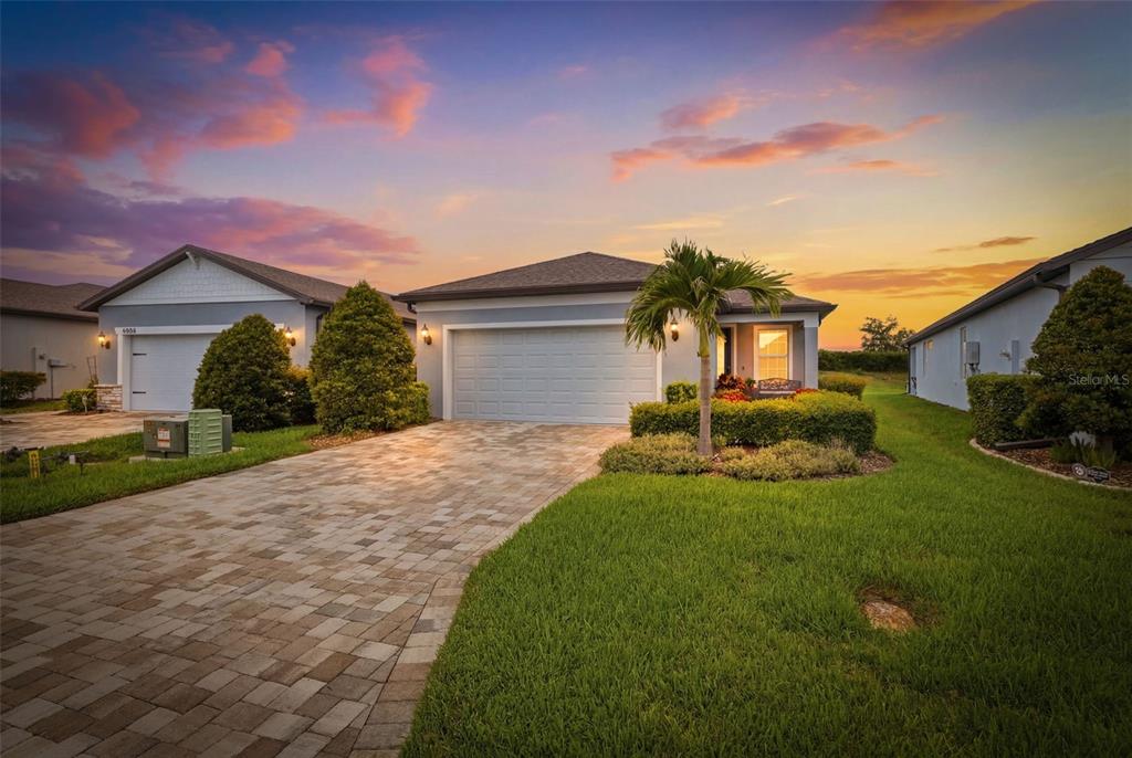 10462 Spring Tide Way Palmetto, FL 34221 - Photo 21 of 21 a front view of a house with a yard and garage