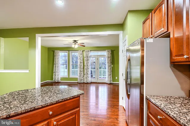 a bathroom with a granite countertop sink and a large mirror