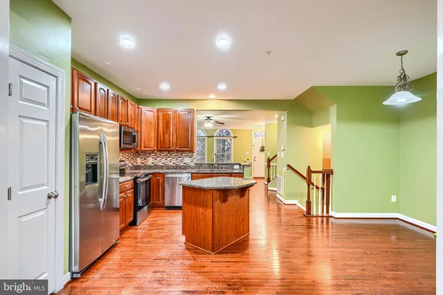 a kitchen with stainless steel appliances granite countertop a stove and a refrigerator