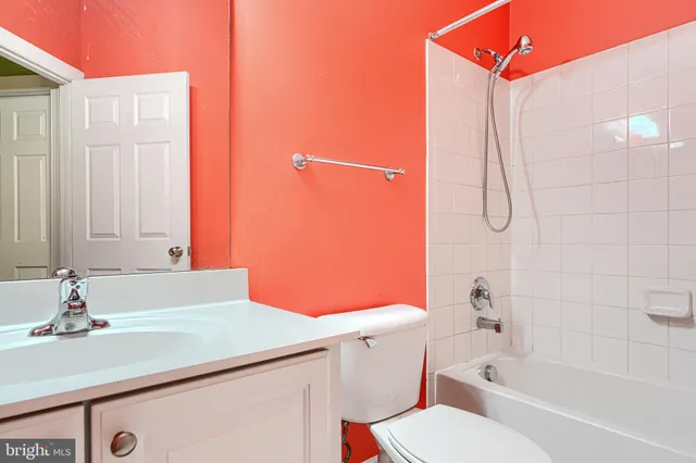 a bathroom with a sink vanity mirror and toilet