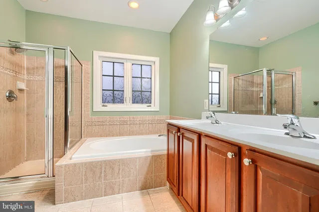 a white bath tub sitting next to a shower