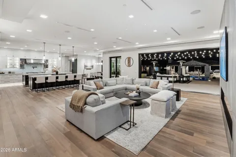 a bedroom with a bed and a large mirror on the dresser