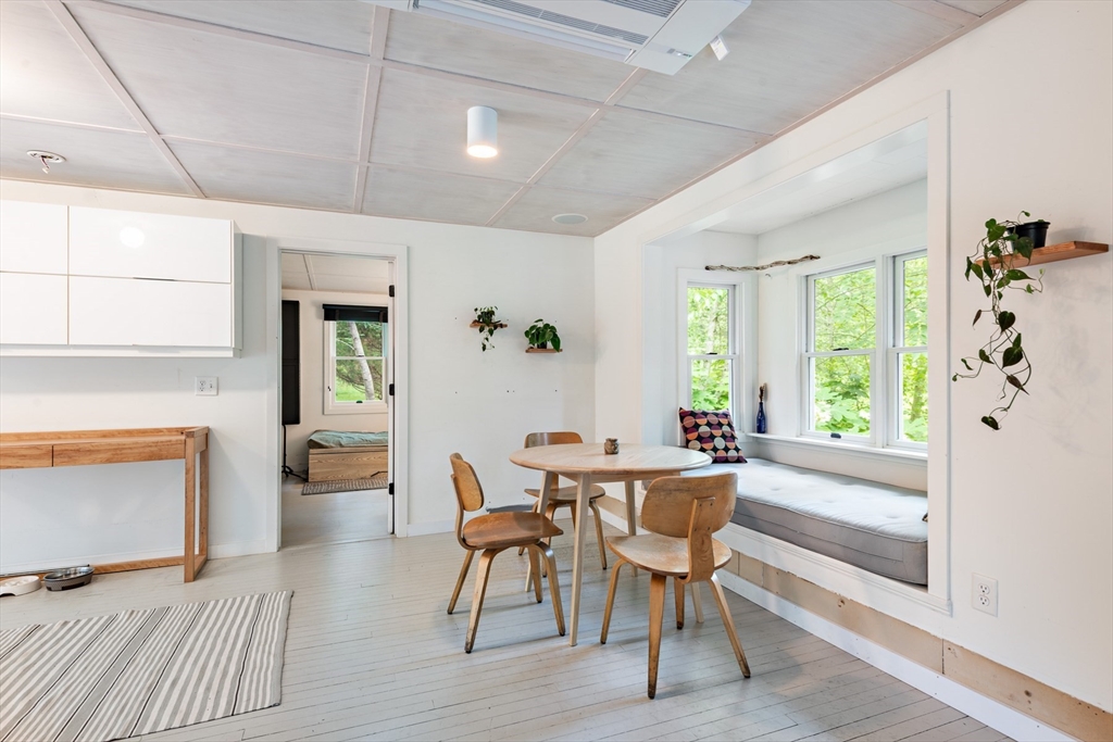 1680 C Drift Road Westport, MA 02790 - Photo 20 of 36 a view of a dining room with furniture window and wooden floor