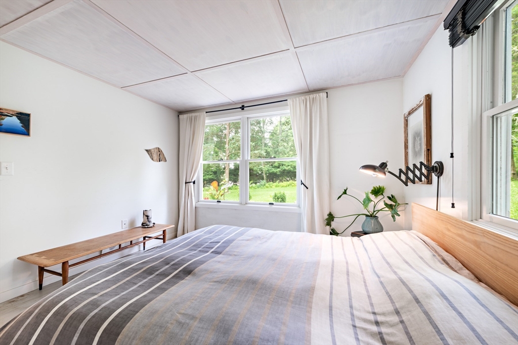 1680 C Drift Road Westport, MA 02790 - Photo 25 of 36 a bed sitting in a bedroom next to a window