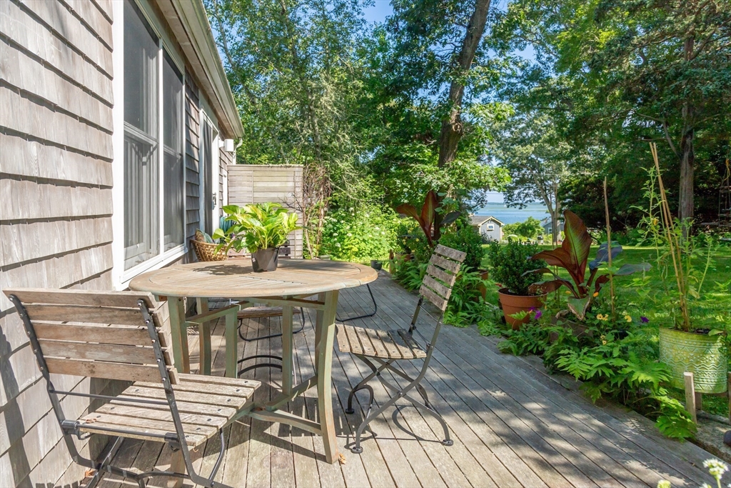 1680 C Drift Road Westport, MA 02790 - Photo 8 of 36 a patio with table and chairs and potted plants
