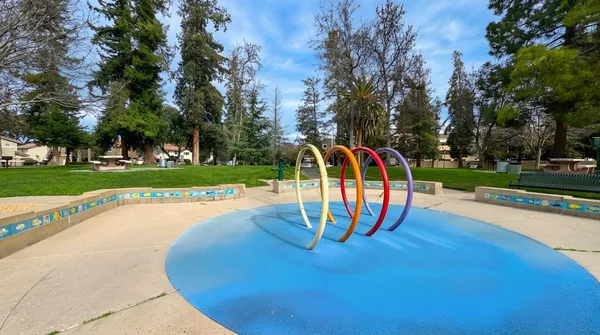 a view of a park with bench and trees