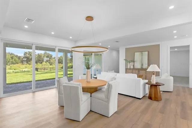 a living room with fireplace furniture and a large window