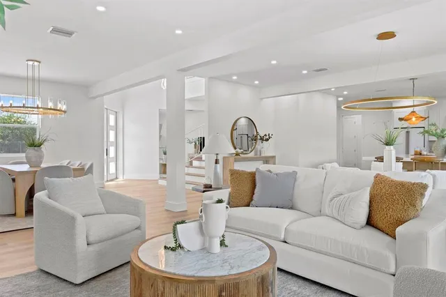 a living room with furniture and a dining table