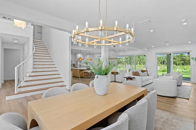 a view of a dining room with furniture and a chandelier