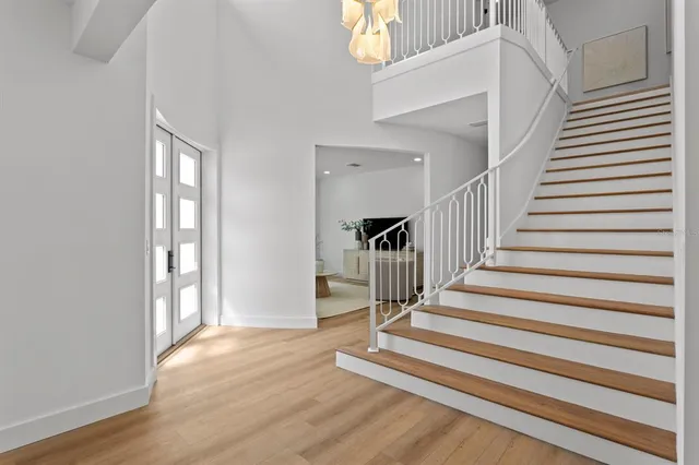 a view of entryway and hall with wooden floor