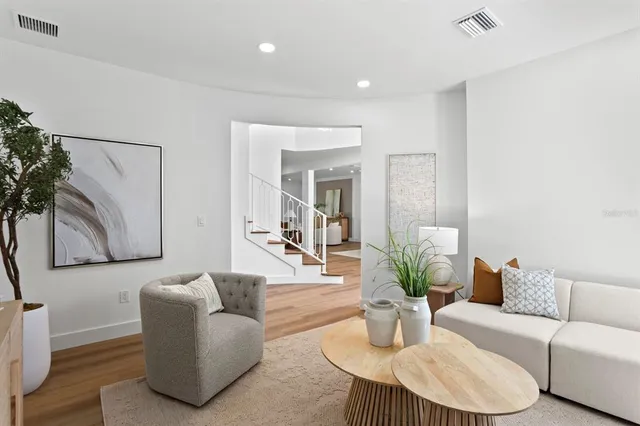 a living room with furniture and a painting