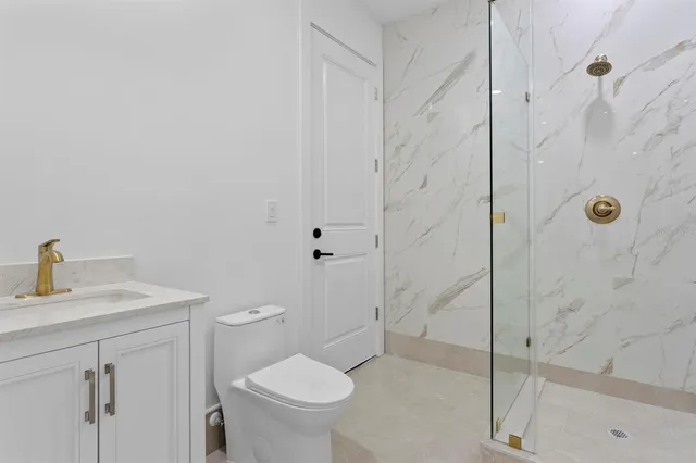 an aerial view of residential house with pool and trees