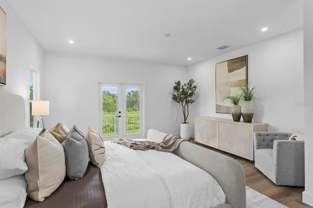 a bed room with a bed and a potted plant