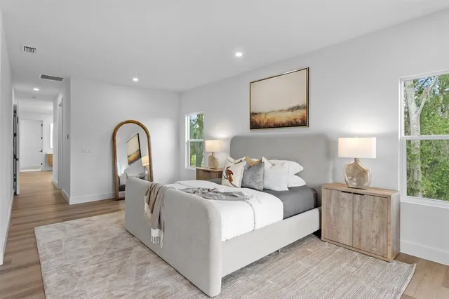 a bedroom with bed and a window