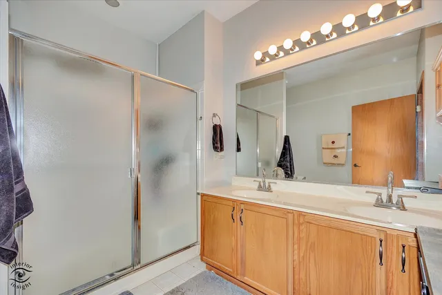 a bathroom with a double vanity sink and a mirror