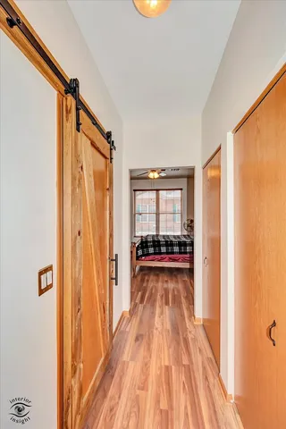 a view of a bedroom with wooden floor and windows