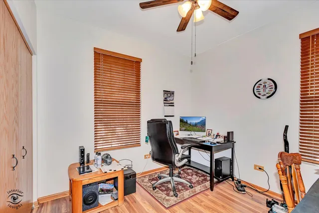 a view of a workspace with furniture and a window