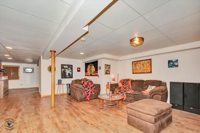 a living room with furniture and painting on the wall