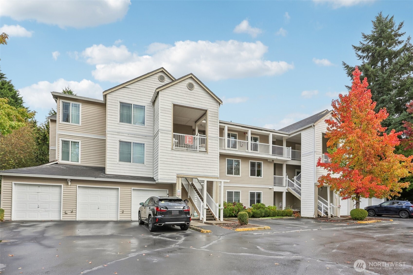 a view of building with cars parked in front of it