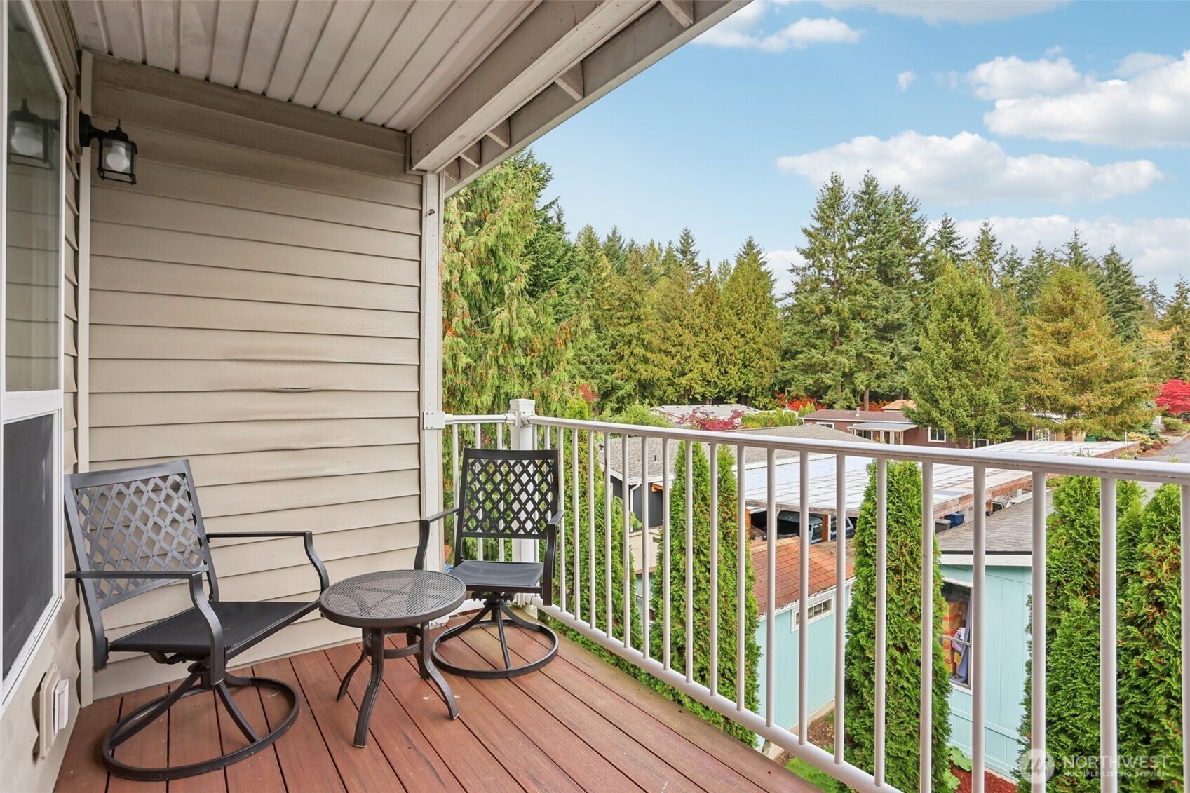 2009 196th Street Southeast, Unit E302 Bothell, WA 98012 - Photo 17 of 21 a view of a balcony with chairs and wooden floor