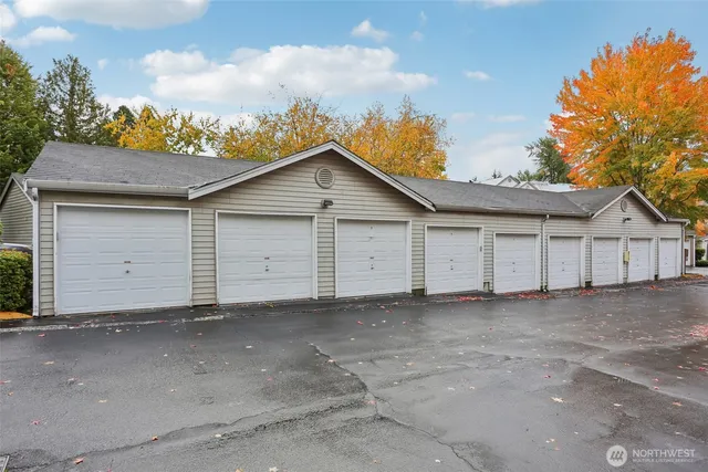 a view of house with garage and small yard