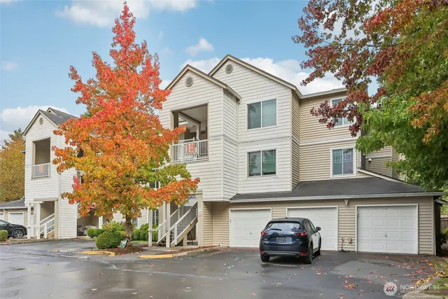 a car parked in front of a white house