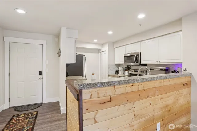 a kitchen with stainless steel appliances granite countertop a stove a sink and a refrigerator