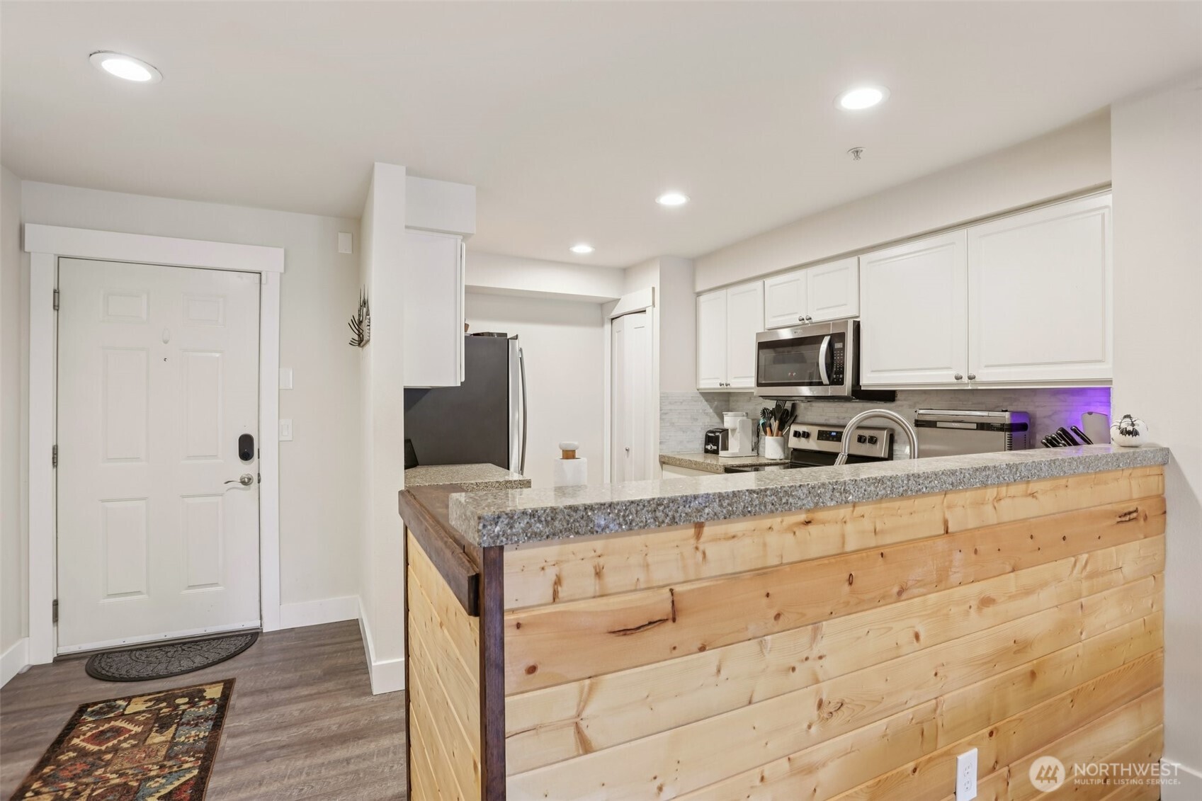 2009 196th Street Southeast, Unit E302 Bothell, WA 98012 - Photo 2 of 21 a kitchen with stainless steel appliances granite countertop a stove a sink and a refrigerator