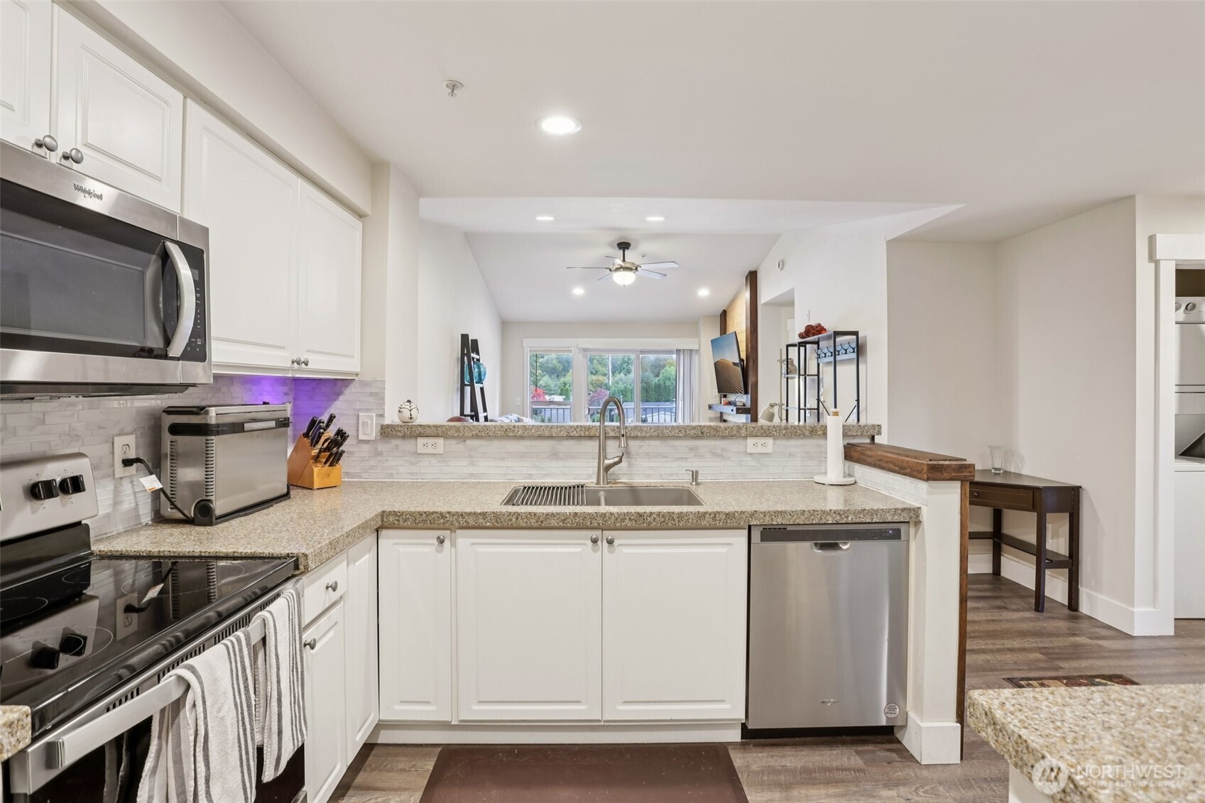2009 196th Street Southeast, Unit E302 Bothell, WA 98012 - Photo 4 of 21 a kitchen with stainless steel appliances granite countertop a sink stove and cabinets