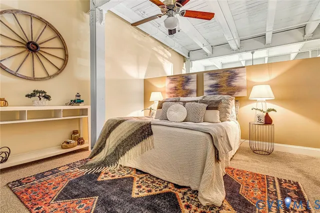 a bedroom with a bed and ceiling fan