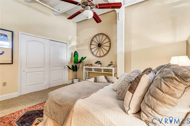 a bedroom with a bed and a potted plant