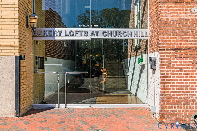 a living room with patio furniture and a painting on the wall