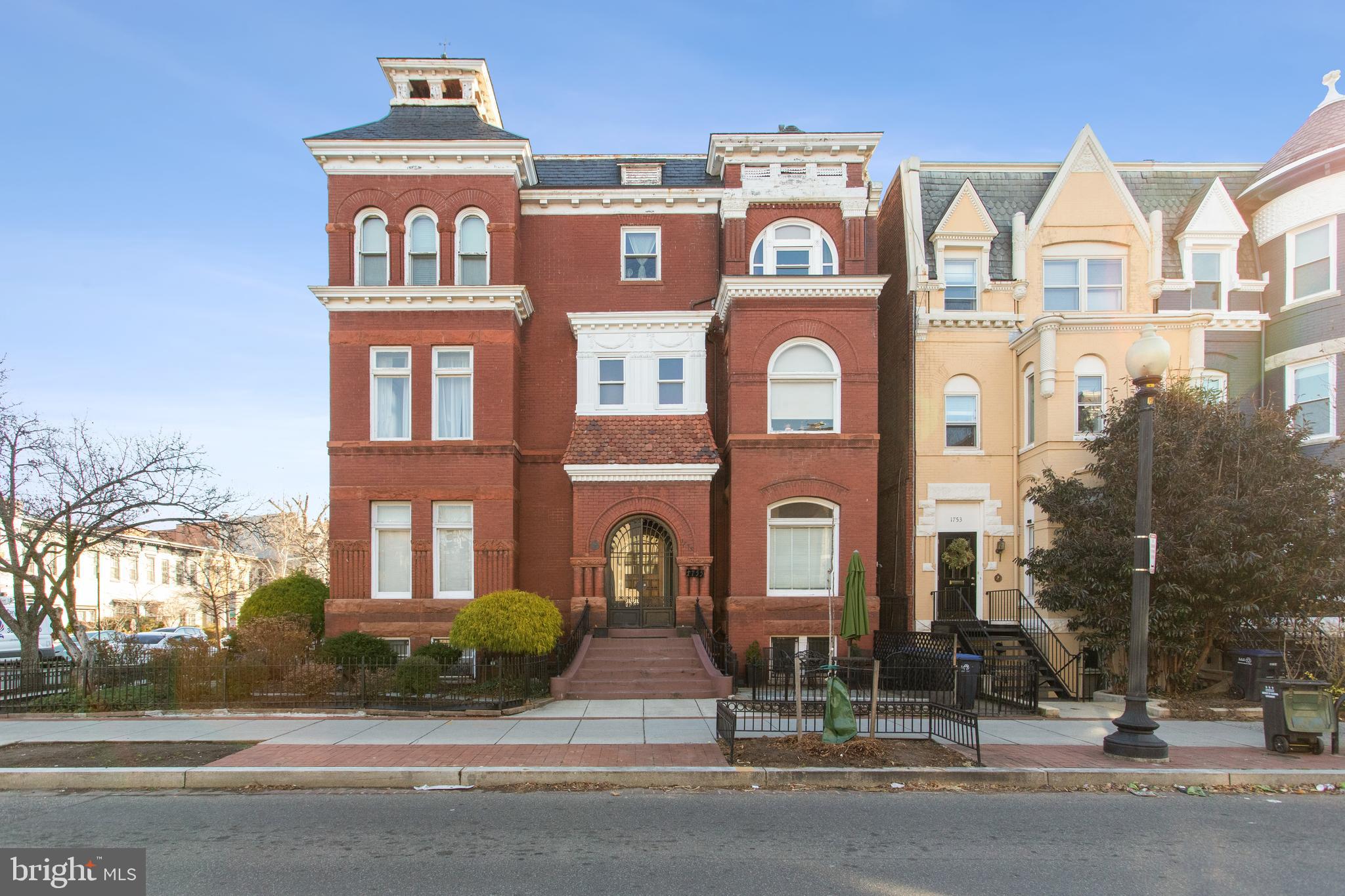 a front view of a residential apartment building with a yard