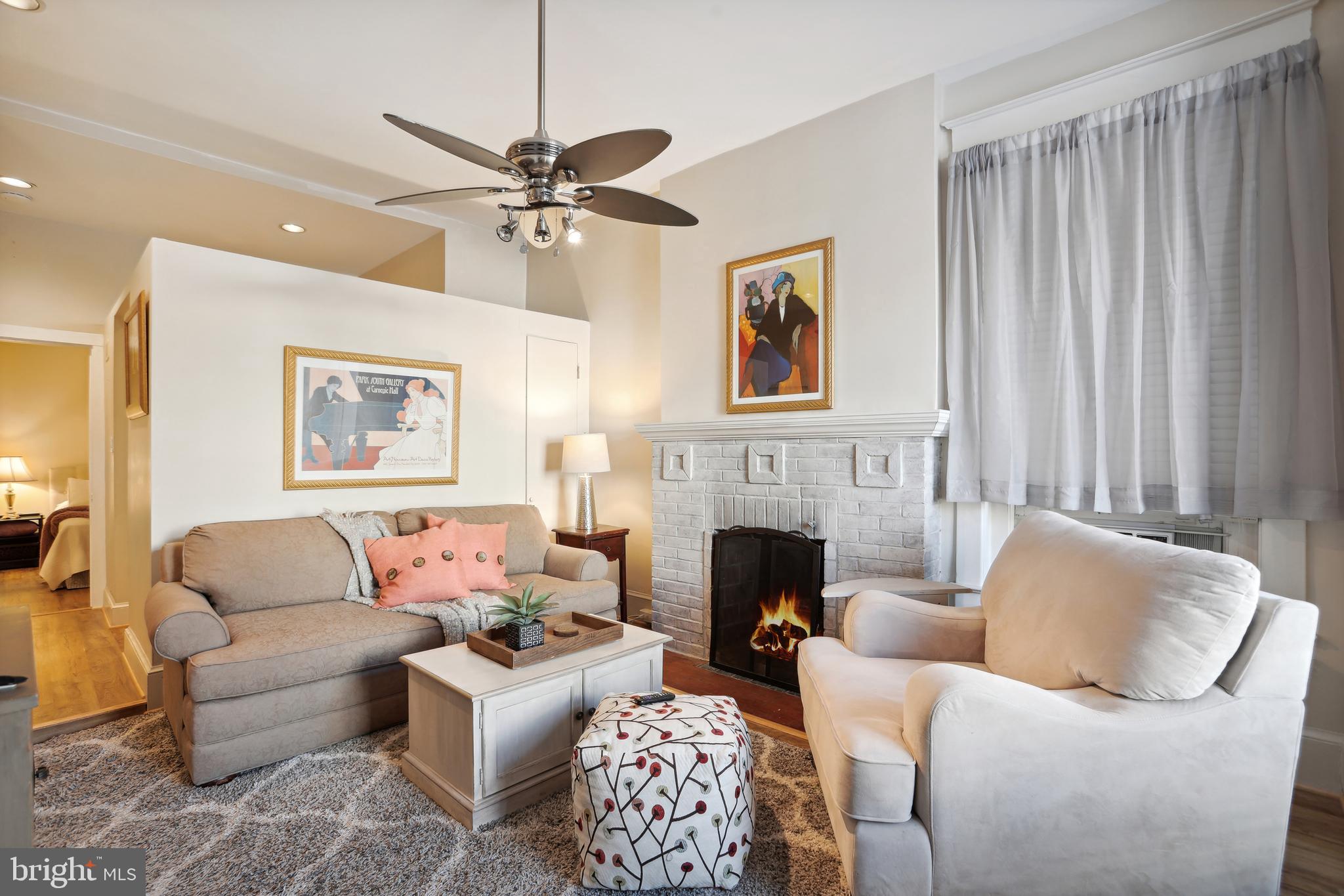 1755 18th Street Northwest, Unit 101 Washington, DC 20009 - Photo 2 of 17 a living room with furniture and a fireplace