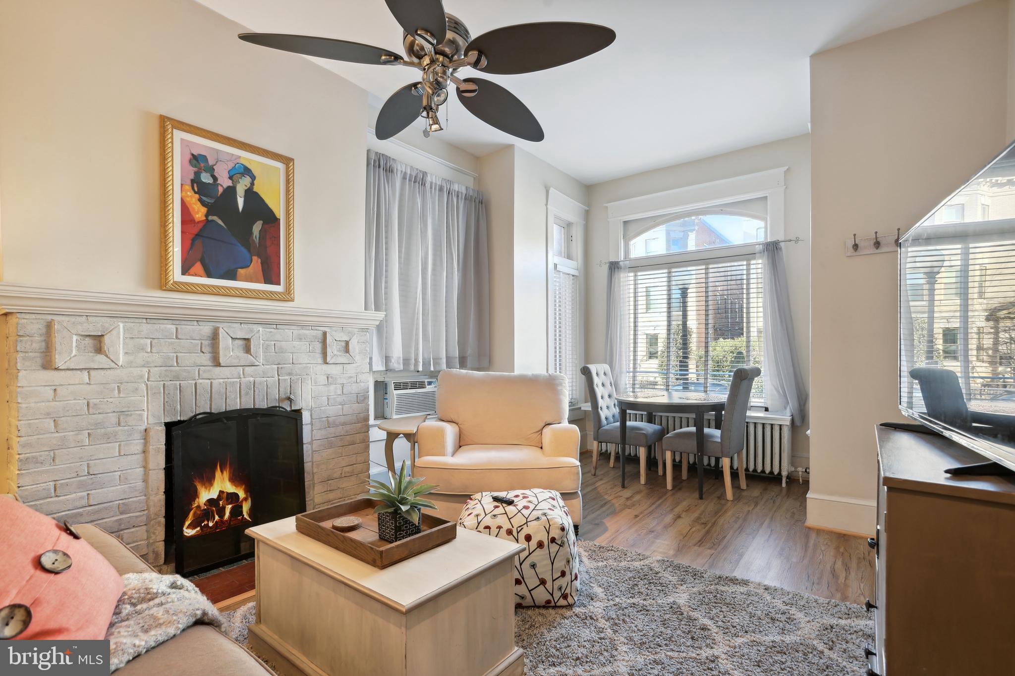 1755 18th Street Northwest, Unit 101 Washington, DC 20009 - Photo 3 of 17 a living room with furniture and a fireplace