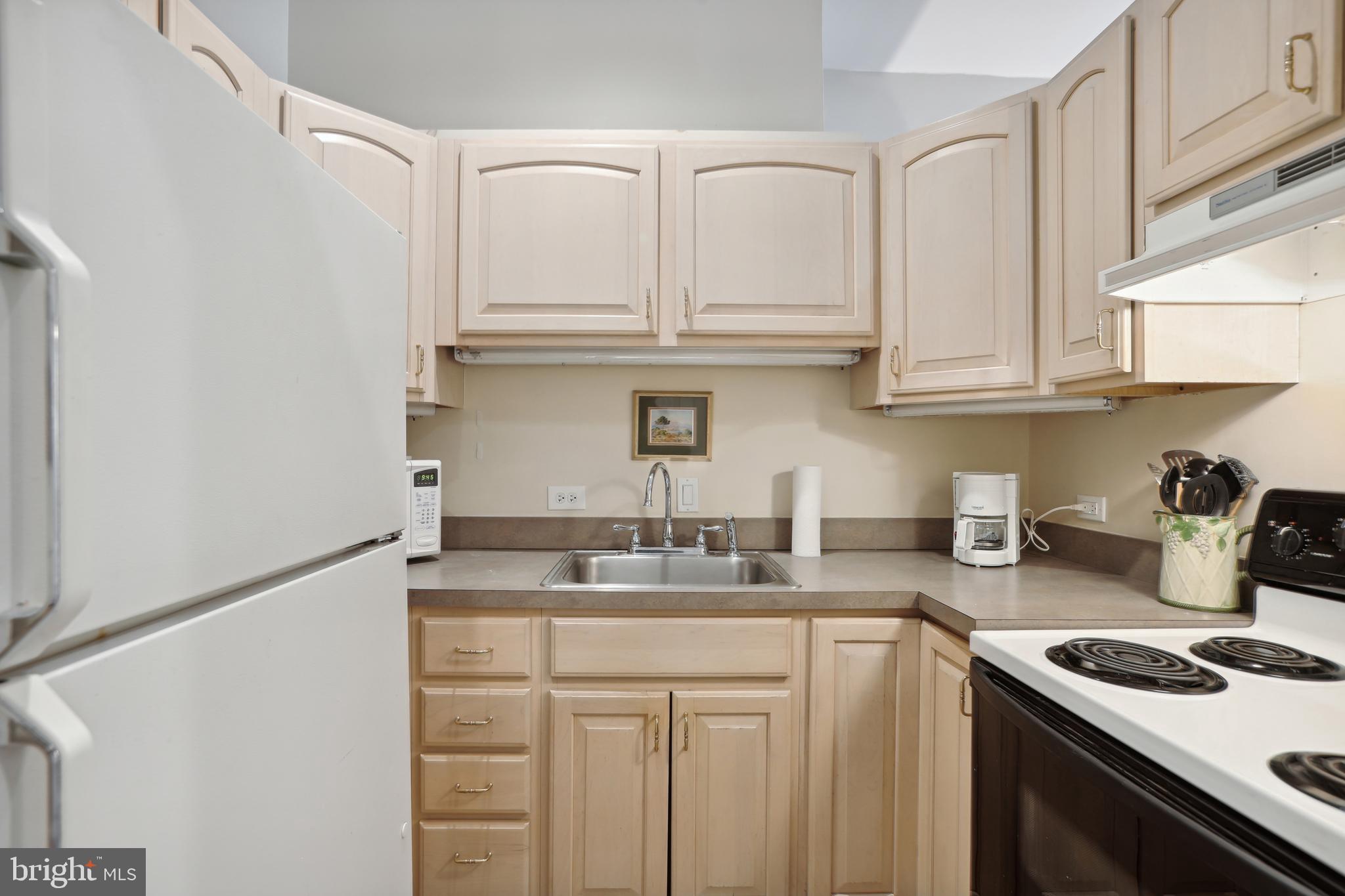 1755 18th Street Northwest, Unit 101 Washington, DC 20009 - Photo 4 of 17 a kitchen with stainless steel appliances granite countertop a sink stove and cabinets
