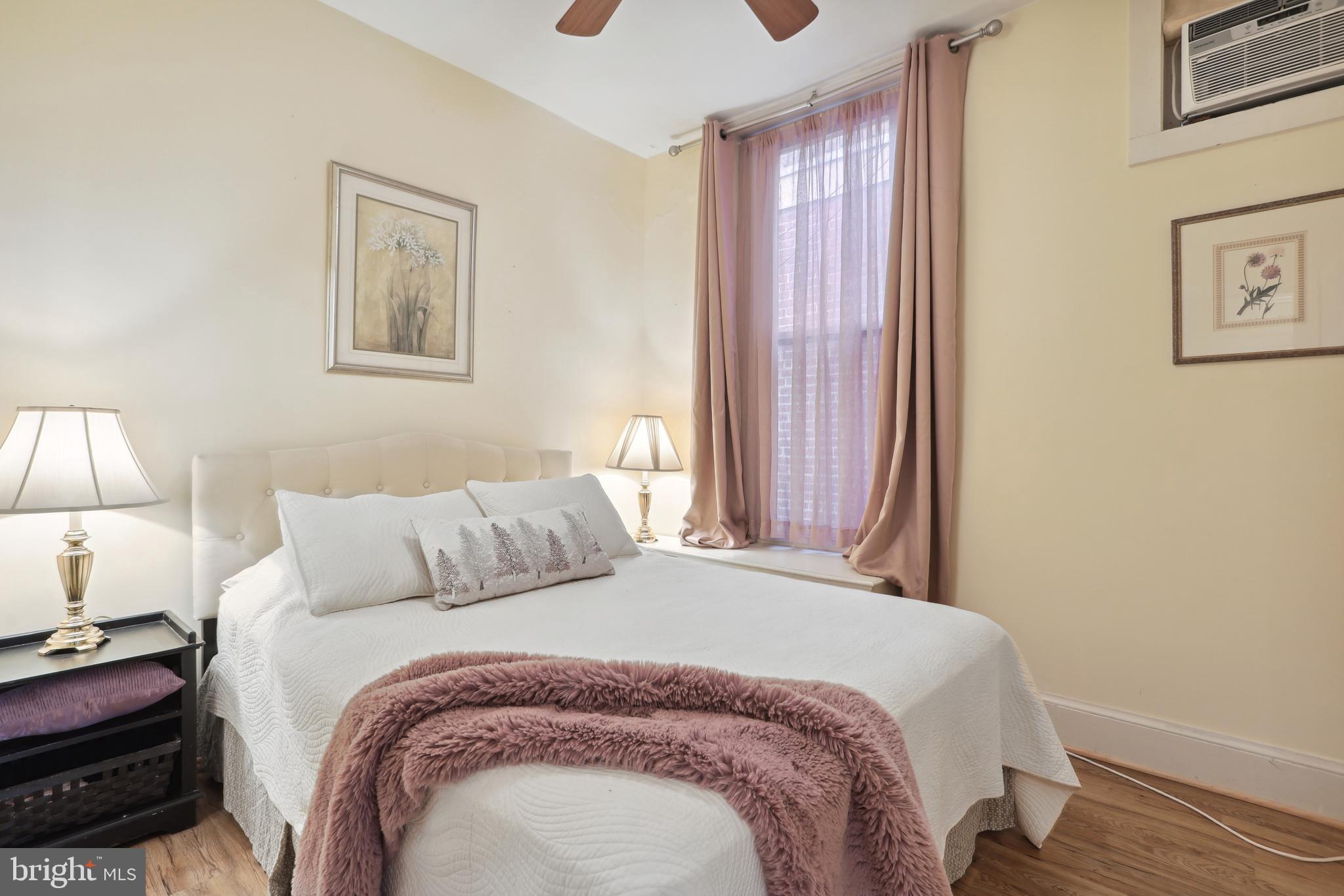 1755 18th Street Northwest, Unit 101 Washington, DC 20009 - Photo 7 of 17 a bedroom with a bed and a lamp